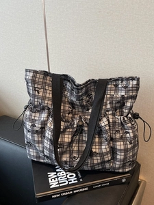 Checkered canvas tote bag with black cartoon print and functional side drawstring pockets