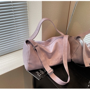 Detail of lavender soft leather tote with Love 105 degree embossed lettering and wide strap