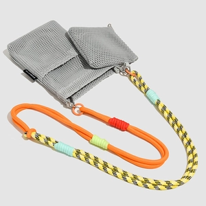 Detail of grey mesh crossbody bag with colorful woven climbing rope shoulder strap