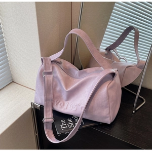 Detailed macro view of light purple leather tote bag with embossed Love 105 text