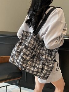 Checkerboard canvas tote bag with drawstring detail and black shoulder straps