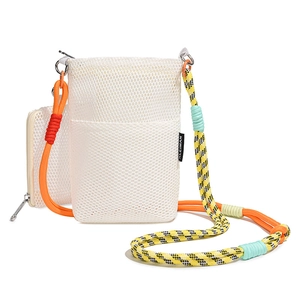Detail of white mesh crossbody bag with multi-color braided rope strap and silver metal clips