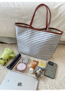 Detail view of large capacity striped canvas tote bag showing spacious inner storage space