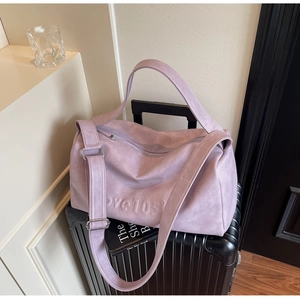 Macro detail of lavender travel tote with love 105 embossed lettering and wide strap