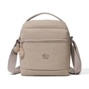 Détail d'un sac bandoulière en nylon kaki montrant le logo, le zip et la bandoulière