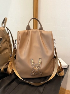 Khaki student backpack with golden sequin bunny pattern and side water bottle pockets