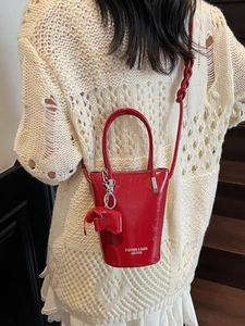 Red patent leather bucket handbag with bow charm and fashion lettering for women