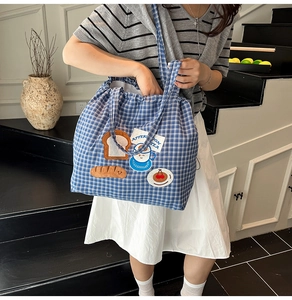Close-up of blue plaid canvas tote bag with 3D afternoon tea cartoon embroidery
