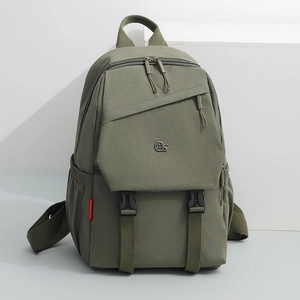 Detail of olive green oxford backpack featuring dual buckle closure and side mesh pocket