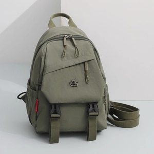 Detail view of the dark green oxford fabric backpack featuring multi-pocket structure