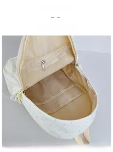 Internal view showing zipper mesh pocket and open compartments in beige star backpack