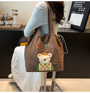 Brown nylon tote bag featuring cute bear embroidery and stylish drawstring closure