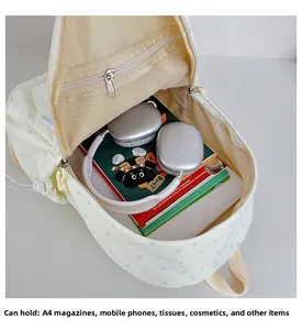 Interior view of beige canvas backpack with blue star patterns showing spacious main compartment
