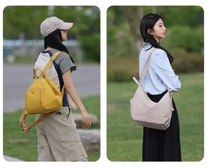 Outdoor detail of bright yellow nylon backpack and beige tote bag on grass