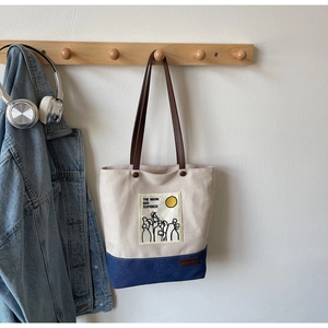 Detail of canvas tote bag with leather handles and Moon and Sixpence print