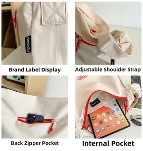 Detail view of beige nylon crossbody bag featuring red zipper cords and internal storage