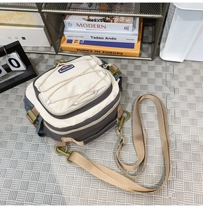 Detail of crossbody bag featuring cross-elastic cords and durable buckle closure
