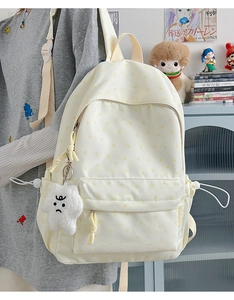 Beige star-print backpack featuring a large capacity main pocket and plush pendant accessory