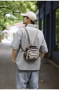 Detail of multi-functional hiking crossbody bag with elastic drawstrings and buckles