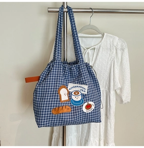 Detail of blue checkered canvas tote bag with cute afternoon tea cartoon embroidery