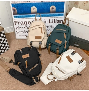 Detailed view of four nylon mini backpacks in beige, green, black and white color options