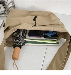 Interior view of khaki nylon drawstring shoulder bag showing large storage capacity