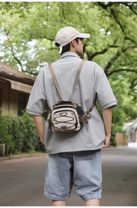 Outdoor shot of the beige crossbody backpack featuring black trim and bungee cord details