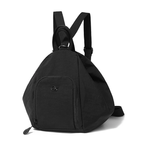 Detail of minimalist black nylon pyramid backpack featuring metal logo and zipper pocket