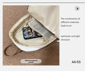 Detail view of the white crossbody bag featuring an internal zipper mesh pocket for storage