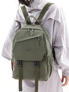 Olive green nylon laptop backpack for women shown from behind on a model outdoors