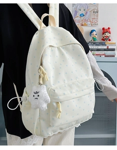 Detail of star print backpack with plush star pendant and elastic side pocket