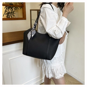 Black litchi grain tote bag with abstract pattern silk scarf shown in lifestyle scene