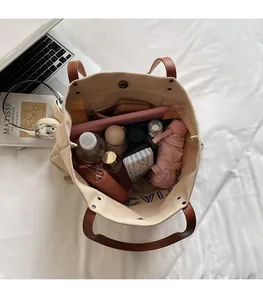 Canvas tote bag interior showing large capacity for laptop and daily essentials