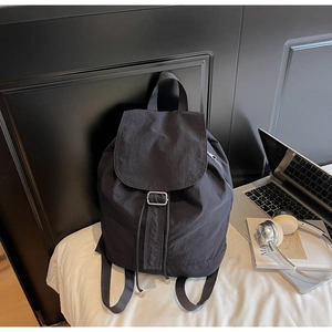 Détail d'un sac à dos en nylon noir minimaliste avec boucles en métal argenté