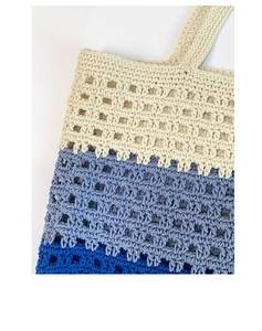 Close-up of contrast knit tote bag showing hollow-out texture and striped weaving detail