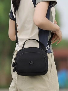Classic black nylon crossbody backpack with multi-layer zippers and metal logo detail