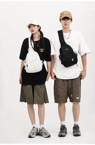 Close-up of casual sling bags with letter C logo on black and white durable canvas