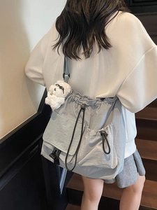 Grey-blue drawstring crossbody bucket bag for women with adjustable strap and cute plush charm