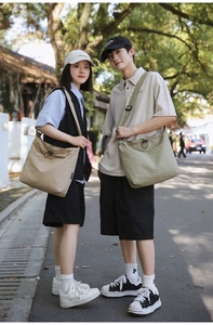 Detailed view of large nylon drawstring bucket bags in beige and green for casual outdoor use