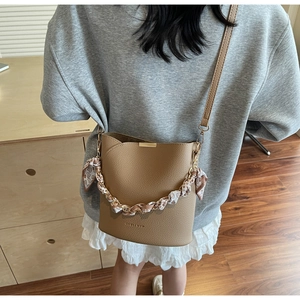 Brown lychee leather bucket bag with silk scarf chain and adjustable shoulder strap