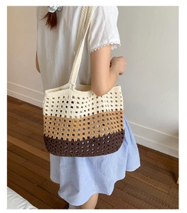 Detail view of tri-color gradient hand-knitted tote bag showing texture and crochet pattern