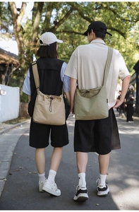Outdoor lifestyle view of large nylon drawstring bucket bags in khaki and army green colors