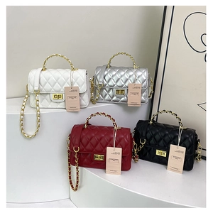 Detail of four quilted PU leather flap bags in white silver burgundy and black with chains