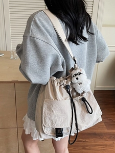 Beige large capacity drawstring crossbody bucket bag with cute plush puppy pendant