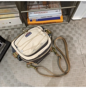 Close-up of hiking crossbody bag with adjustable bungee cords and sturdy nylon fabric