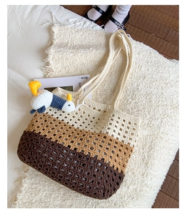 Detail of hand-woven gradient crochet tote bag with hollow pattern and duck charm