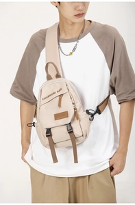 Detailed view of beige crossbody chest bag with adjustable strap and buckle closure