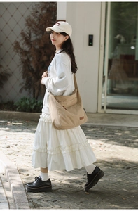 Close-up of beige waterproof Oxford cloth tote showing durable fabric and wide strap