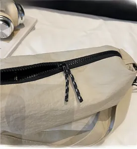 Macro detail of beige nylon fabric and durable black smooth zipper on women handbag