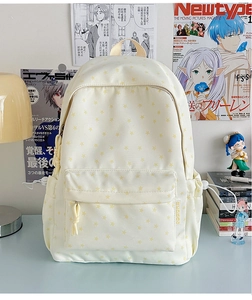 Detail of beige canvas backpack with star prints and functional drawstring side pockets